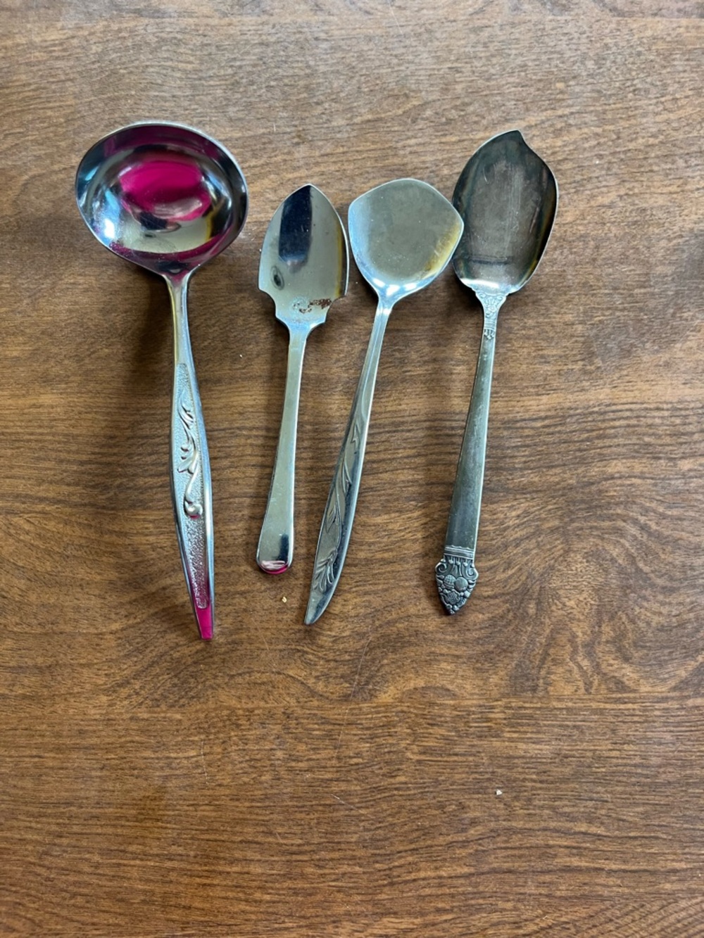 Set of four serving utensils , jelly server, serving spoon , sugar spoon and oth